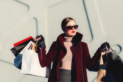 Shopper carrying several shopping bags